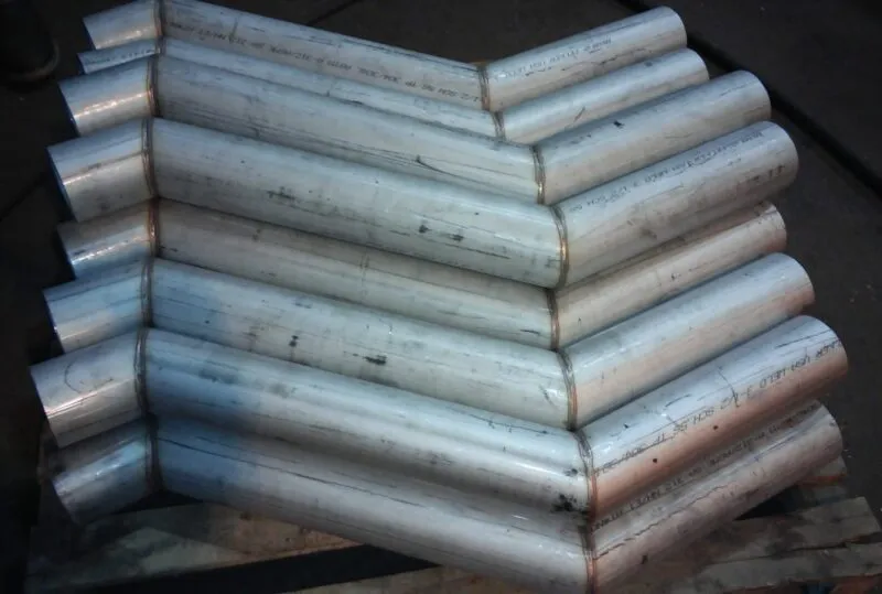 stack of stainless steel fabricated pipe offsets